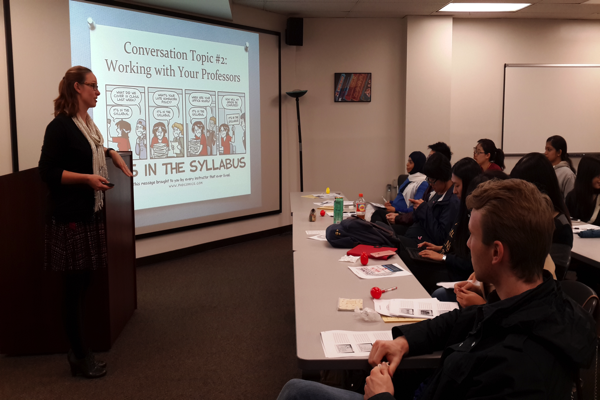 Presenter in front of screen at english workshop