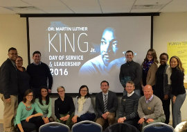 group in front of mlk presentation screen