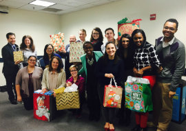 group of people holding wrapped gifts