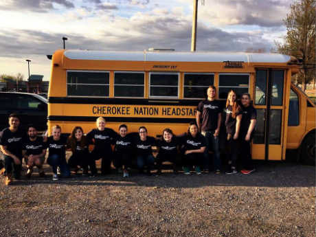 group of people in front of school bus
