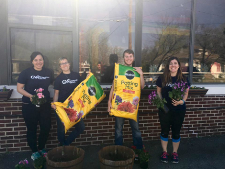 students holding potting soil
