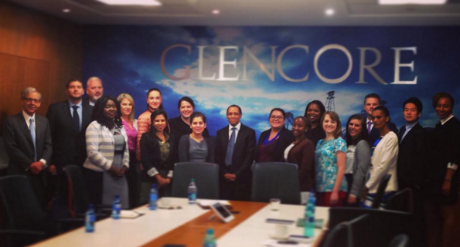 group in front of clencore sign