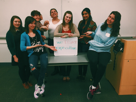 group of people holding up a sign with dry erase