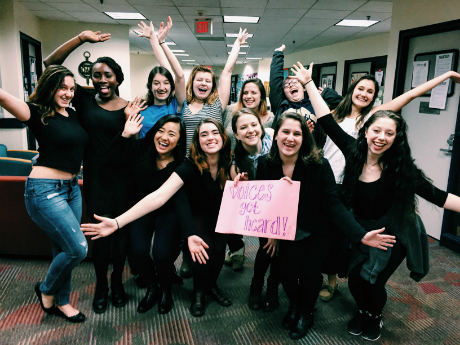 group of people holding up a sign