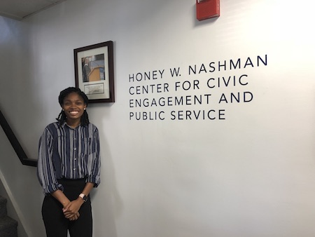Tereese Smith stands in front of the Honey W. Nashman Center logo